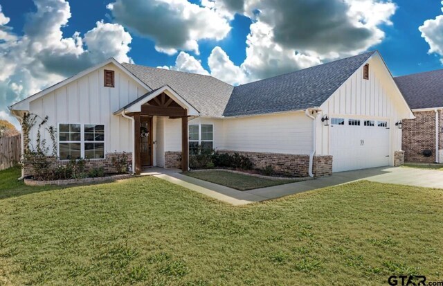 view of front facade with a garage and a front lawn