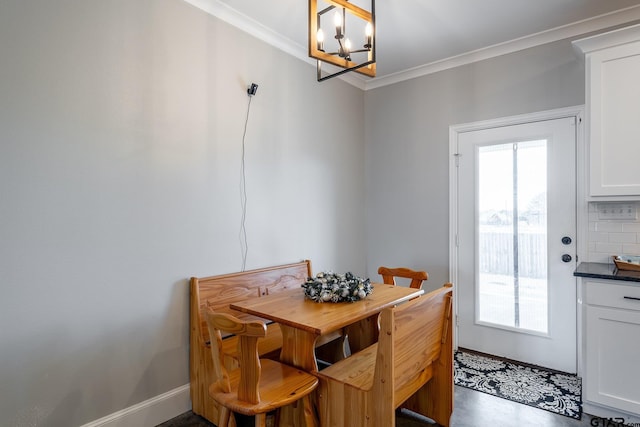 dining room with a notable chandelier and crown molding