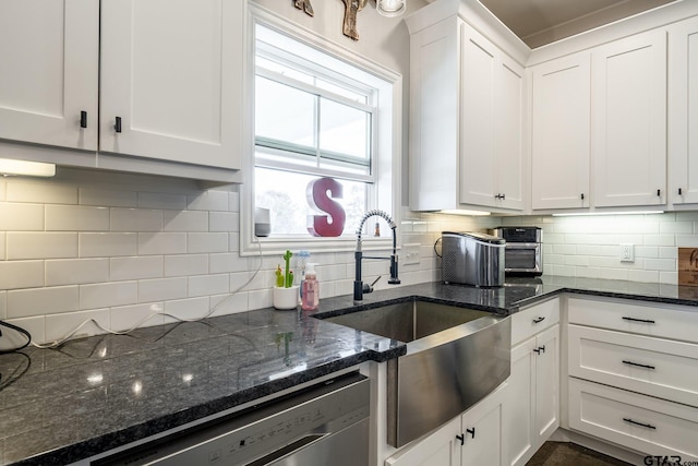 kitchen featuring dark stone counters, tasteful backsplash, and white cabinets