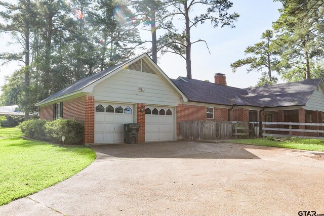 8310 Columbia Dr, Tyler, TX 75703 - view of property exterior featuring brick siding, driveway, a garage, and a chimney