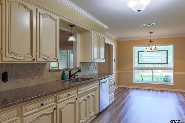 8310 Columbia Dr, Tyler, TX 75703 - kitchen with cream cabinetry, stainless steel dishwasher, a sink, baseboards, and crown molding