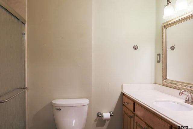 8310 Columbia Dr, Tyler, TX 75703 - full bathroom with vanity, toilet, and a shower with door