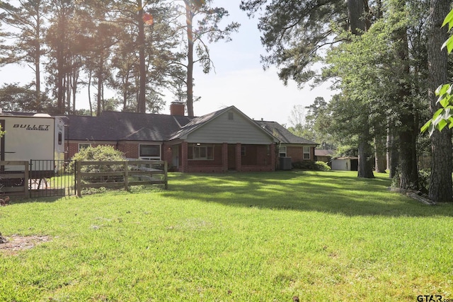 8310 Columbia Dr, Tyler, TX 75703 - rear view of house with brick siding and a chimney
