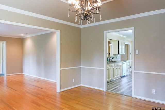 8310 Columbia Dr, Tyler, TX 75703 - unfurnished room featuring ornamental molding, light wood-style floors, a sink, a chandelier, and baseboards