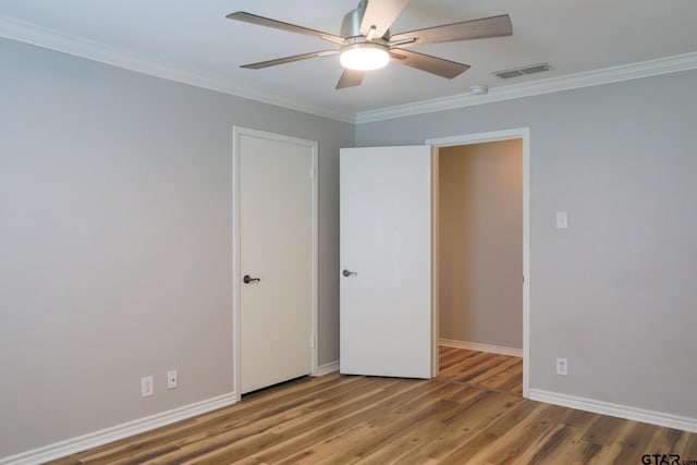 8310 Columbia Dr, Tyler, TX 75703 - unfurnished bedroom with ornamental molding, wood finished floors, baseboards, and a ceiling fan