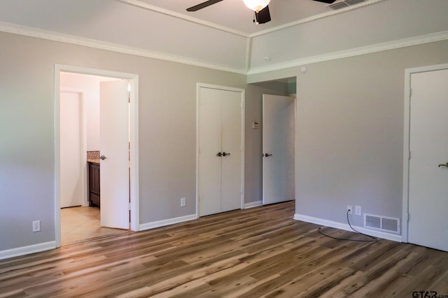 8310 Columbia Dr, Tyler, TX 75703 - unfurnished bedroom featuring wood finished floors, crown molding, baseboards, ceiling fan, and connected bathroom