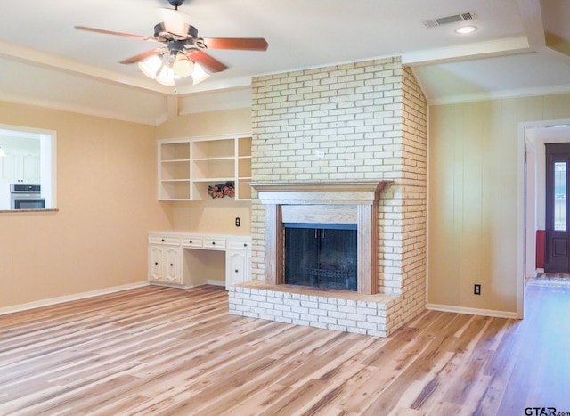 8310 Columbia Dr, Tyler, TX 75703 - unfurnished living room with wood finished floors, ceiling fan, baseboards, a brick fireplace, and crown molding