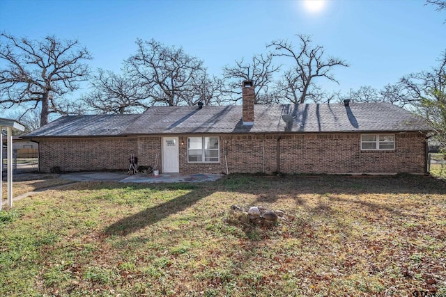 rear view of property with a yard