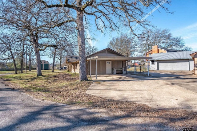 exterior space with an outbuilding and a carport