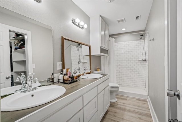 bathroom with vanity, toilet, hardwood / wood-style floors, and a shower with curtain