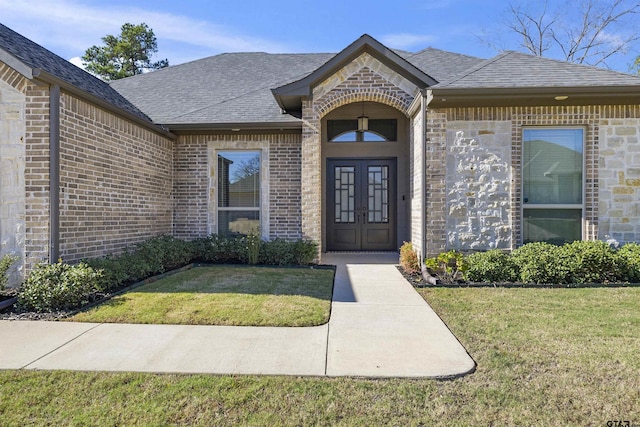 property entrance with a lawn and french doors