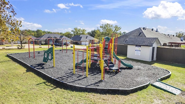 view of playground with a storage unit and a lawn