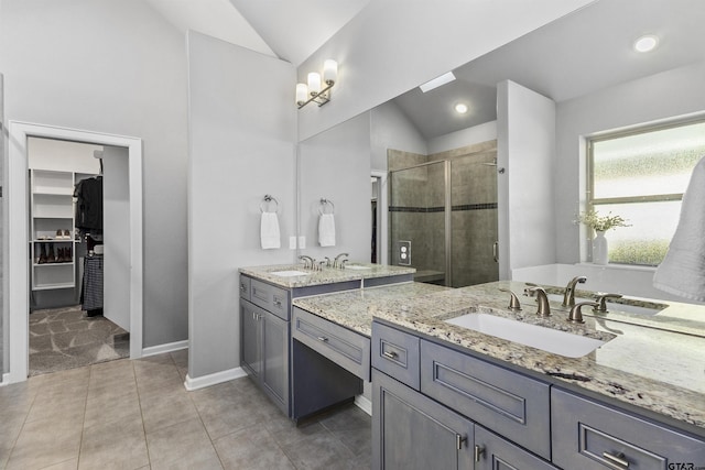 bathroom with walk in shower, lofted ceiling, and vanity