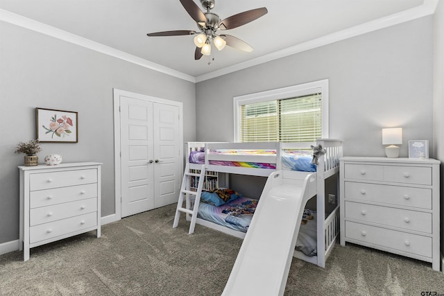 bedroom with dark colored carpet, a closet, ceiling fan, and ornamental molding