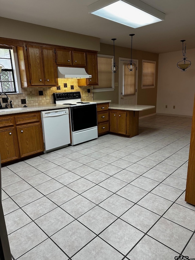 811 Windmill Ln, Athens, TX 75751 - kitchen with white dishwasher, electric stove, under cabinet range hood, a peninsula, and light countertops