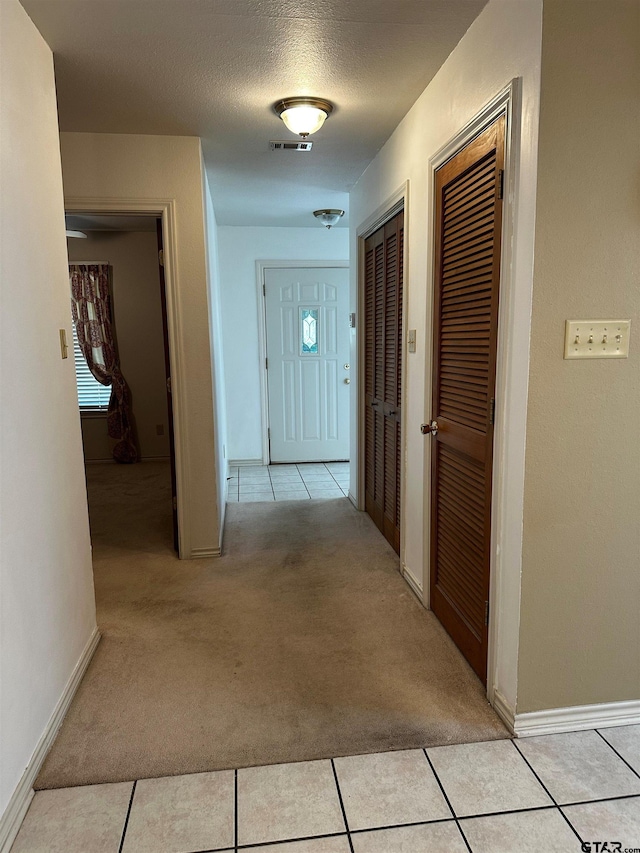 811 Windmill Ln, Athens, TX 75751 - corridor featuring light carpet, light tile patterned floors, and baseboards