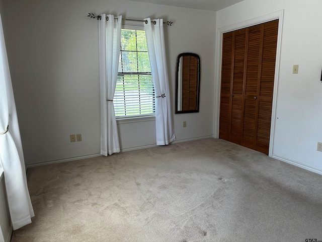 811 Windmill Ln, Athens, TX 75751 - unfurnished bedroom featuring carpet floors, a closet, and baseboards