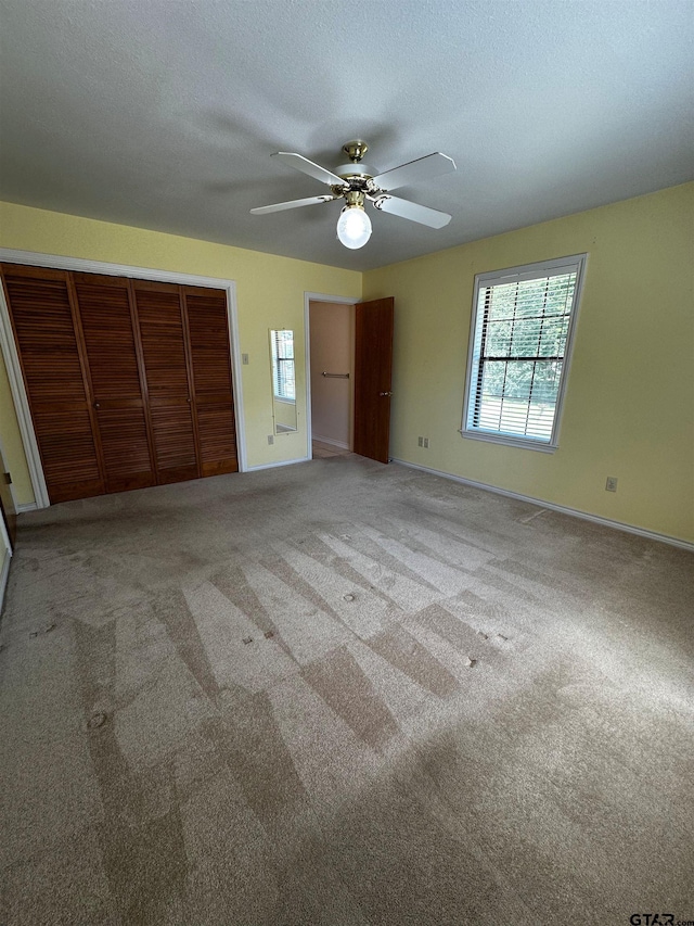 811 Windmill Ln, Athens, TX 75751 - unfurnished bedroom with a closet, baseboards, carpet floors, and ceiling fan
