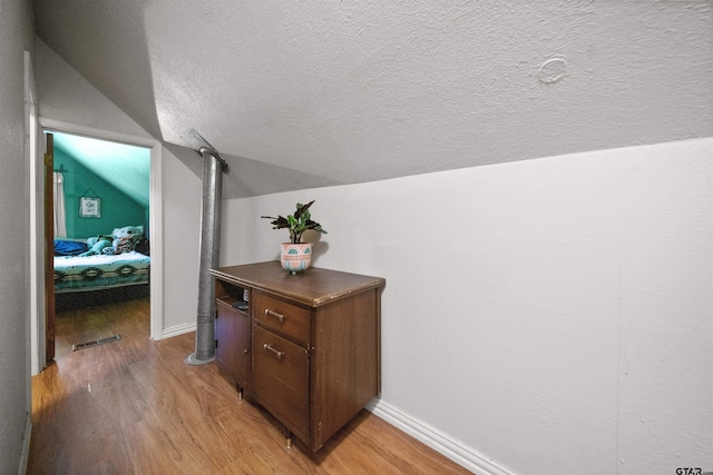 110 Utah St, Van, TX 75790 - hall featuring vaulted ceiling, light wood-style flooring, and a textured ceiling