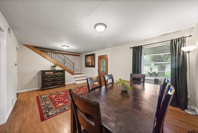 110 Utah St, Van, TX 75790 - dining room with wood finished floors, stairway, plenty of natural light, and a textured ceiling