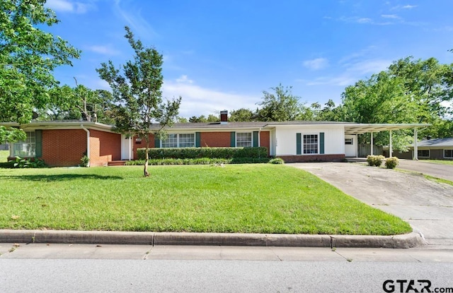 1209 E 8th St, Tyler, TX 75701 - ranch-style house with brick siding, driveway, a front lawn, a carport, and a chimney