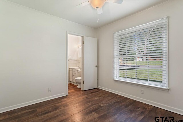 1209 E 8th St, Tyler, TX 75701 - unfurnished bedroom featuring dark wood finished floors, ornamental molding, ensuite bath, and a ceiling fan
