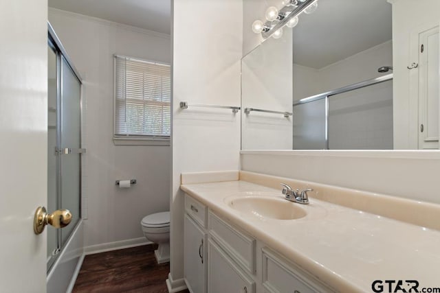 1209 E 8th St, Tyler, TX 75701 - full bathroom featuring vanity, wood finished floors, ornamental molding, and enclosed tub / shower combo