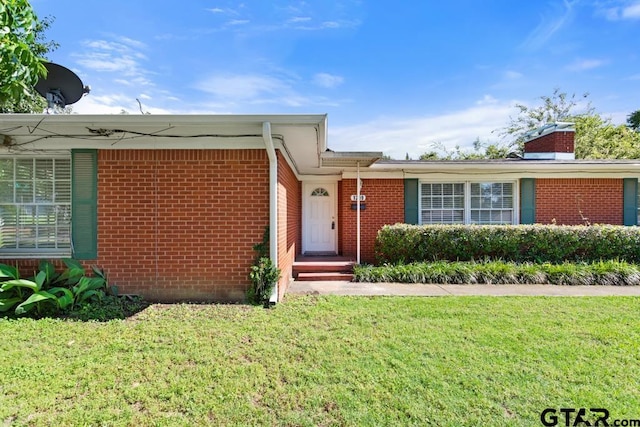 1209 E 8th St, Tyler, TX 75701 - view of front of property with brick siding and a front lawn