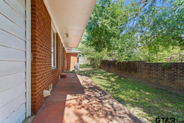 1209 E 8th St, Tyler, TX 75701 - fenced backyard with a patio area