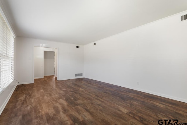 1209 E 8th St, Tyler, TX 75701 - spare room with dark wood-style floors and baseboards
