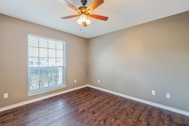 empty room with dark wood-style floors, a textured ceiling, baseboards, and a ceiling fan