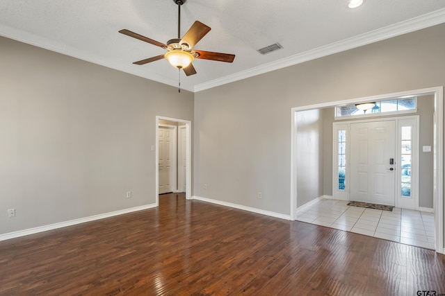 entrance foyer featuring visible vents, crown molding, and hardwood / wood-style flooring