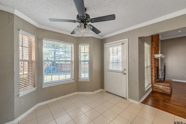 interior space with a healthy amount of sunlight, tile patterned flooring, and crown molding