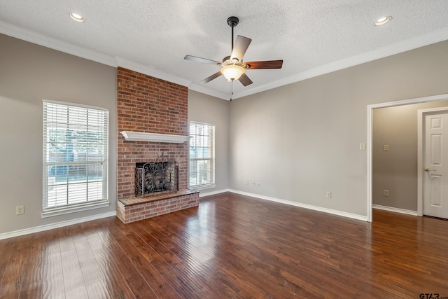 unfurnished living room with crown molding, a fireplace, ceiling fan, and wood finished floors