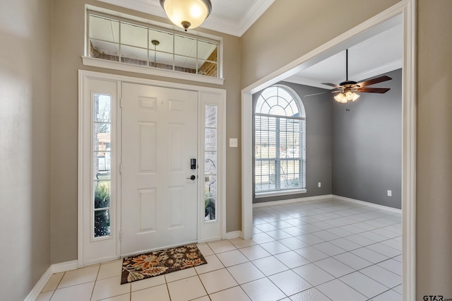 foyer featuring baseboards, light tile patterned flooring, and crown molding