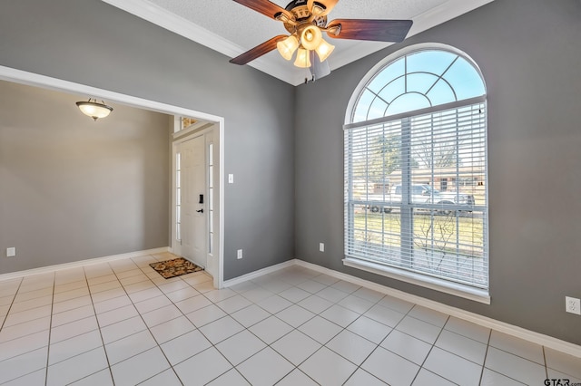 unfurnished room with light tile patterned floors, a textured ceiling, a ceiling fan, and baseboards