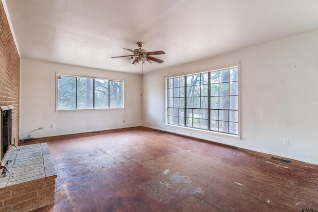 unfurnished living room featuring baseboards, a brick fireplace, visible vents, and a ceiling fan