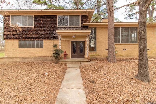 split level home with brick siding and crawl space