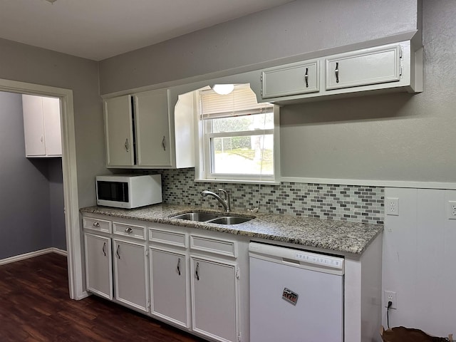 kitchen with decorative backsplash, sink, white appliances, and white cabinetry