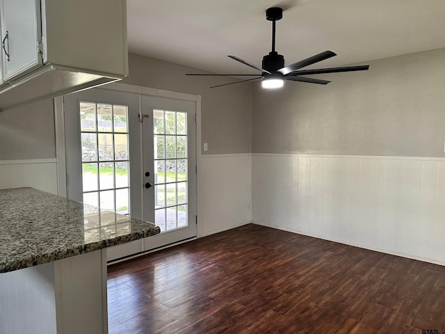 doorway featuring dark wood-type flooring, ceiling fan, and french doors