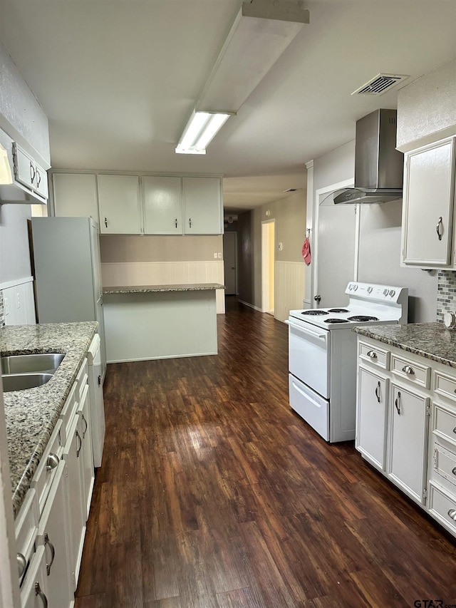 kitchen featuring wall chimney range hood, stone counters, white cabinetry, white range with electric cooktop, and dark hardwood / wood-style flooring