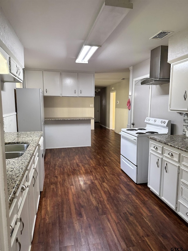 kitchen with stone counters, electric range, dark wood-type flooring, white cabinets, and wall chimney exhaust hood