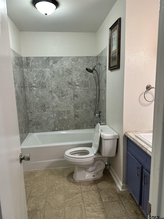 full bathroom with toilet, vanity, and tiled shower / bath