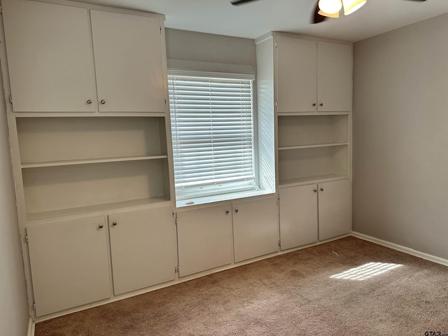 interior space with light carpet, ceiling fan, and plenty of natural light