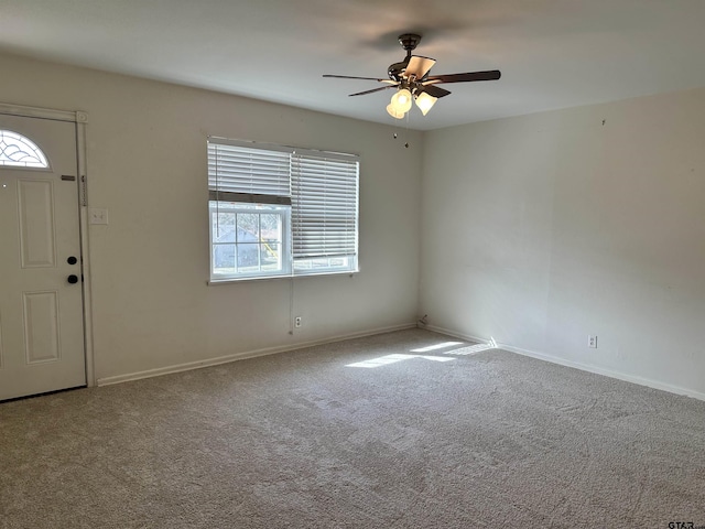 entrance foyer with carpet floors and ceiling fan