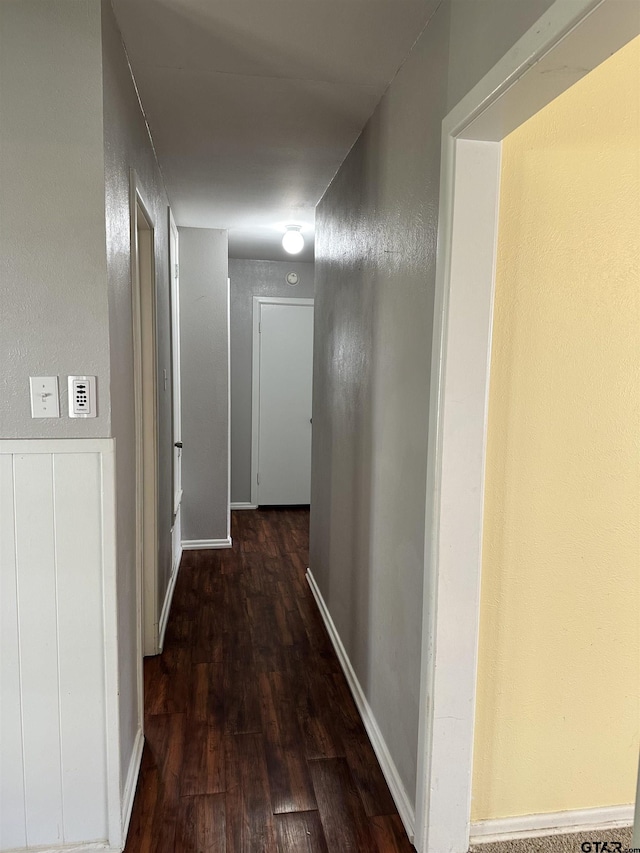 hallway with dark hardwood / wood-style floors