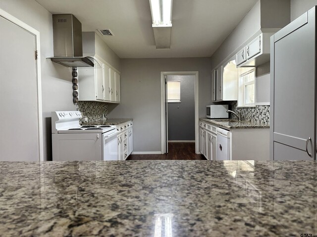 kitchen with white cabinetry, wall chimney exhaust hood, and white appliances