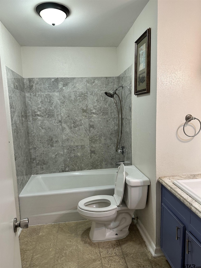 full bathroom featuring toilet, tiled shower / bath, and vanity