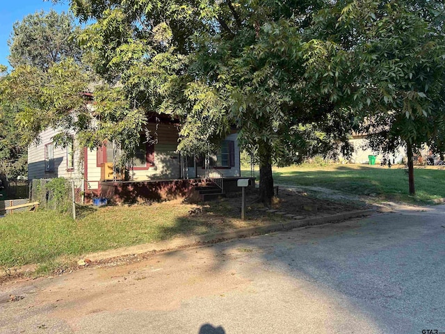 obstructed view of property with a front yard