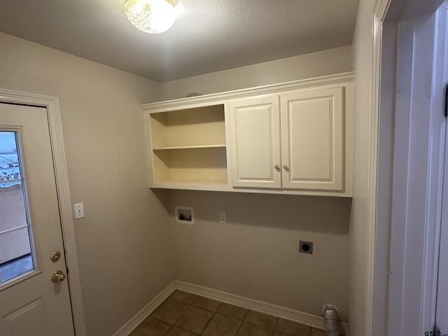 807 Brownwood Cir, Lindale, TX 75771 - washroom with hookup for an electric dryer, cabinet space, baseboards, dark tile patterned flooring, and washer hookup